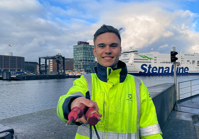 Employee of the PORT OF KIEL with cable in hand