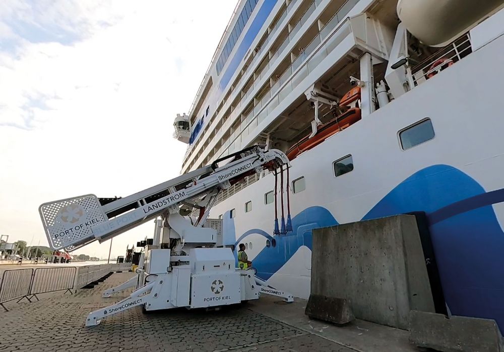 Shore power cable trolley in front of a cruise ship